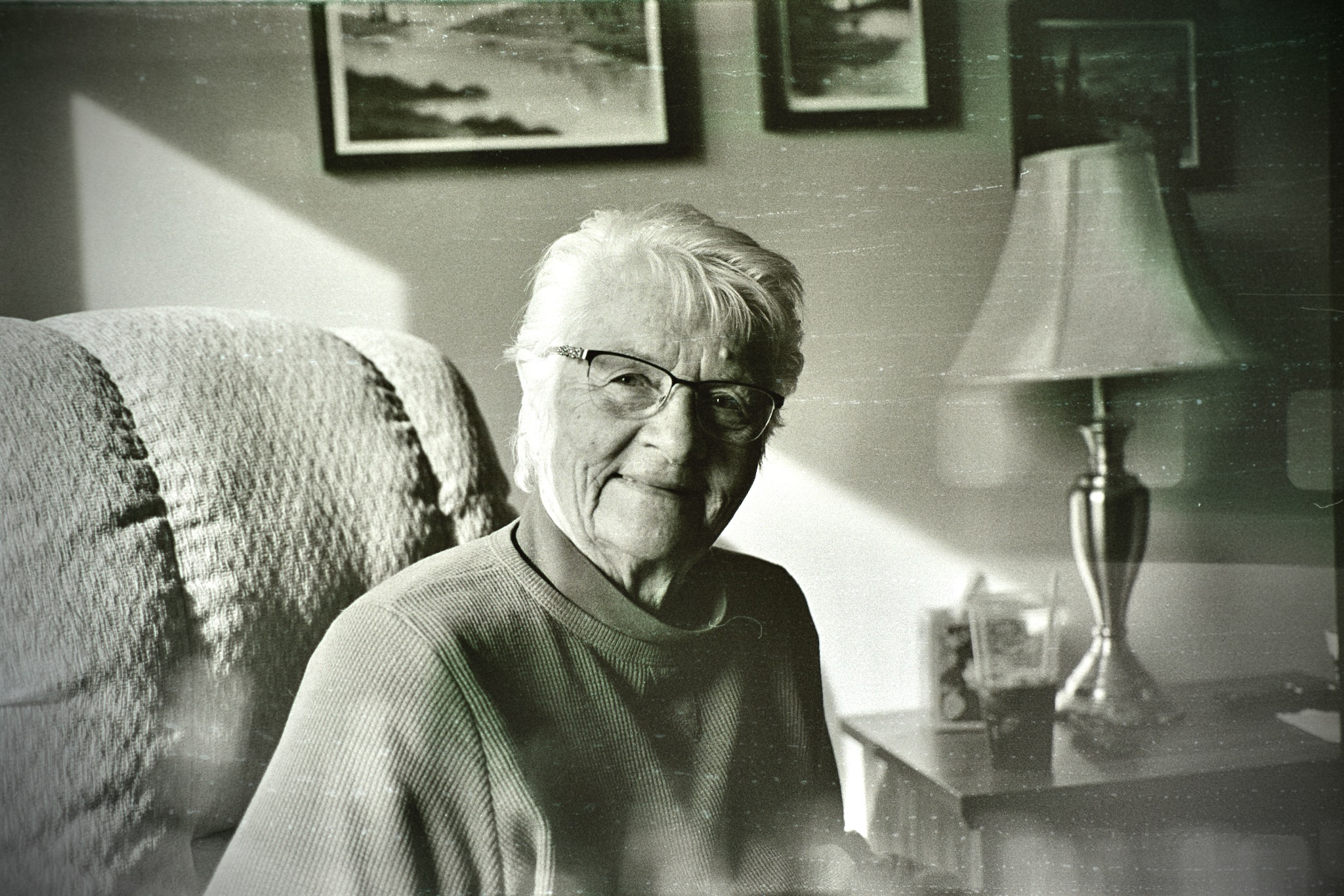 Bonnie J Ross, seated at home with a gentle smile.